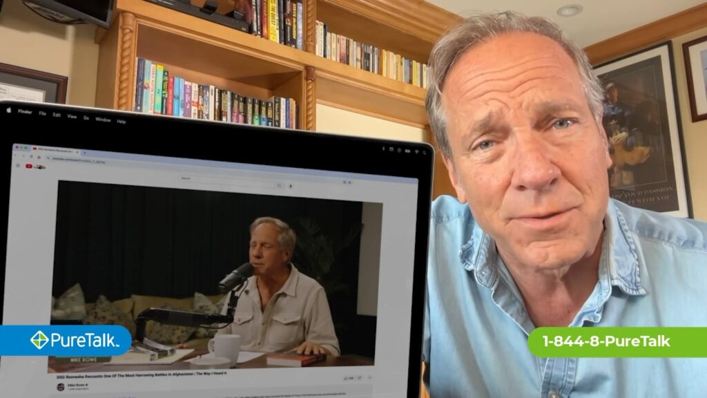 Mike Rowe next to a laptop showing a video with him interviewing